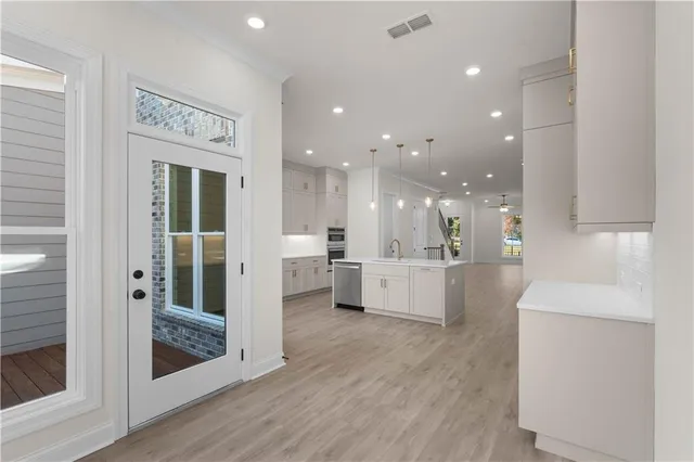 an empty room with wooden floor and window