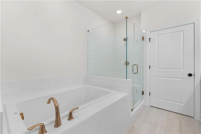 a bathroom with a sink a toilet and a large mirror