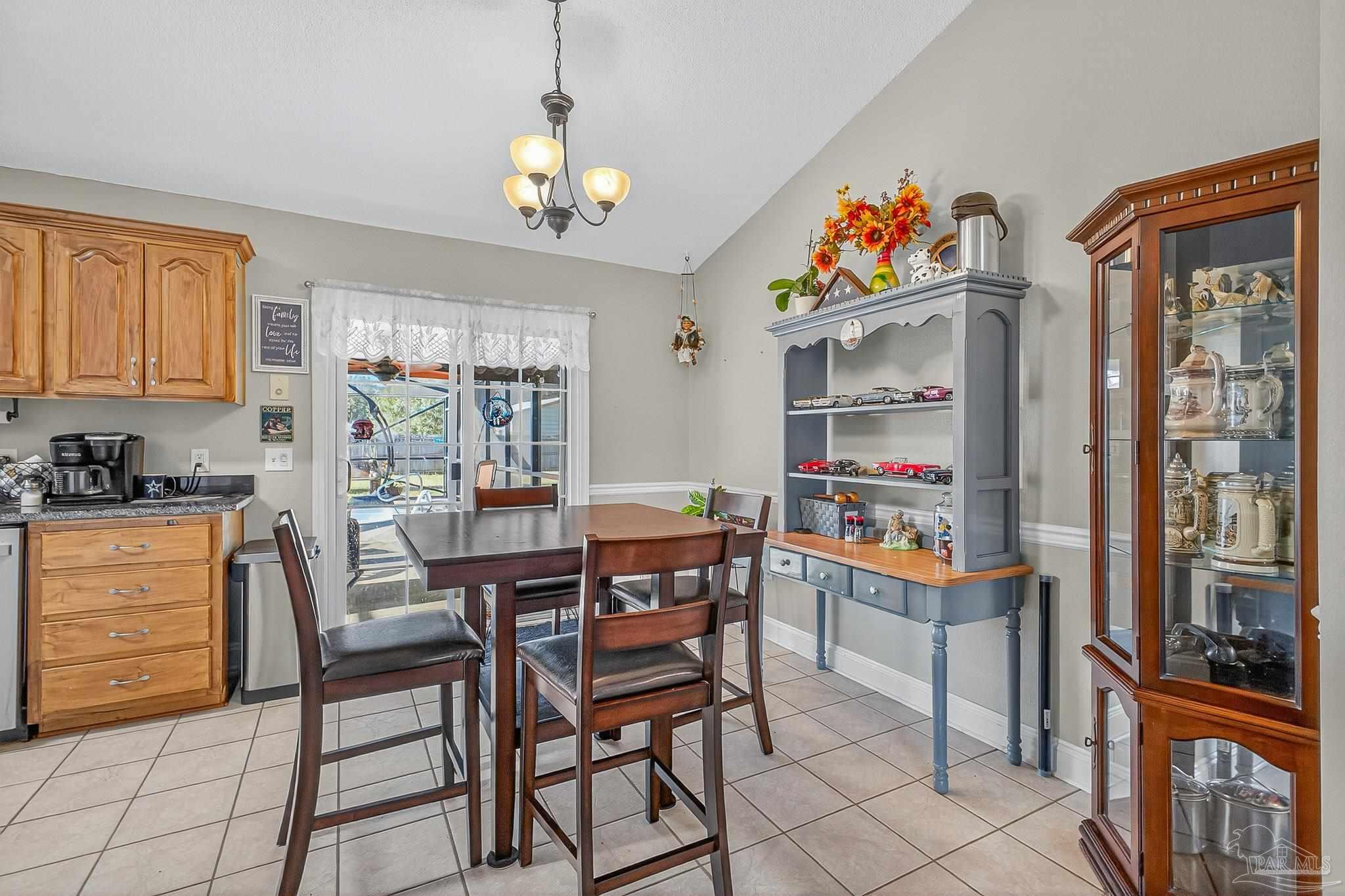 5361 Willard Norris Road Milton, FL 32570 - Photo 11 of 51 a dining room with furniture a rug and a window