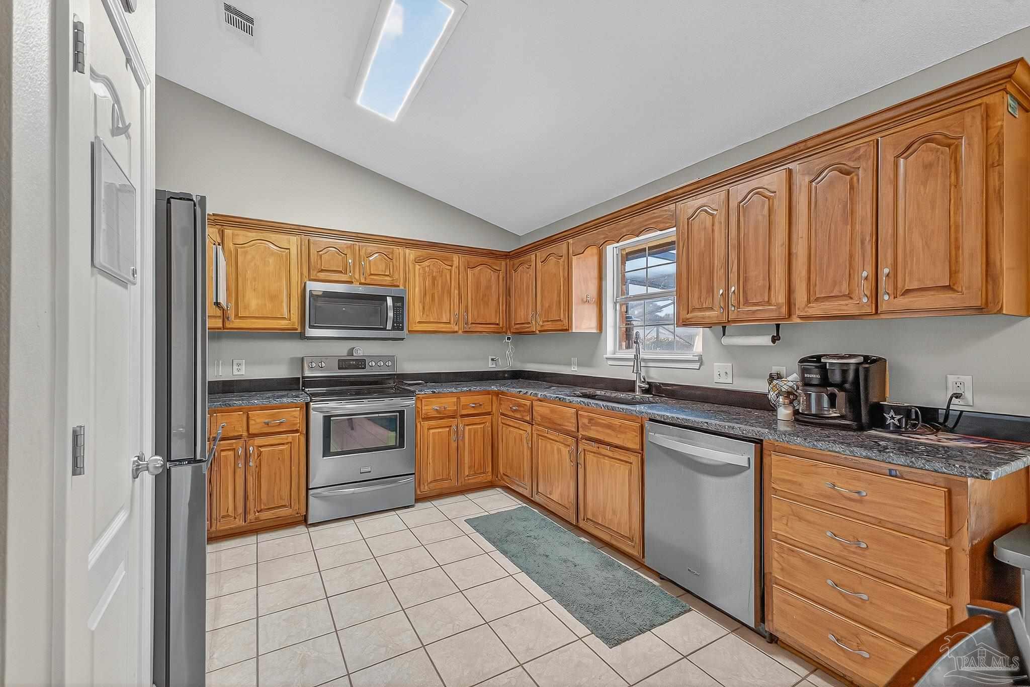 5361 Willard Norris Road Milton, FL 32570 - Photo 14 of 51 a kitchen with stainless steel appliances granite countertop a stove sink and cabinets