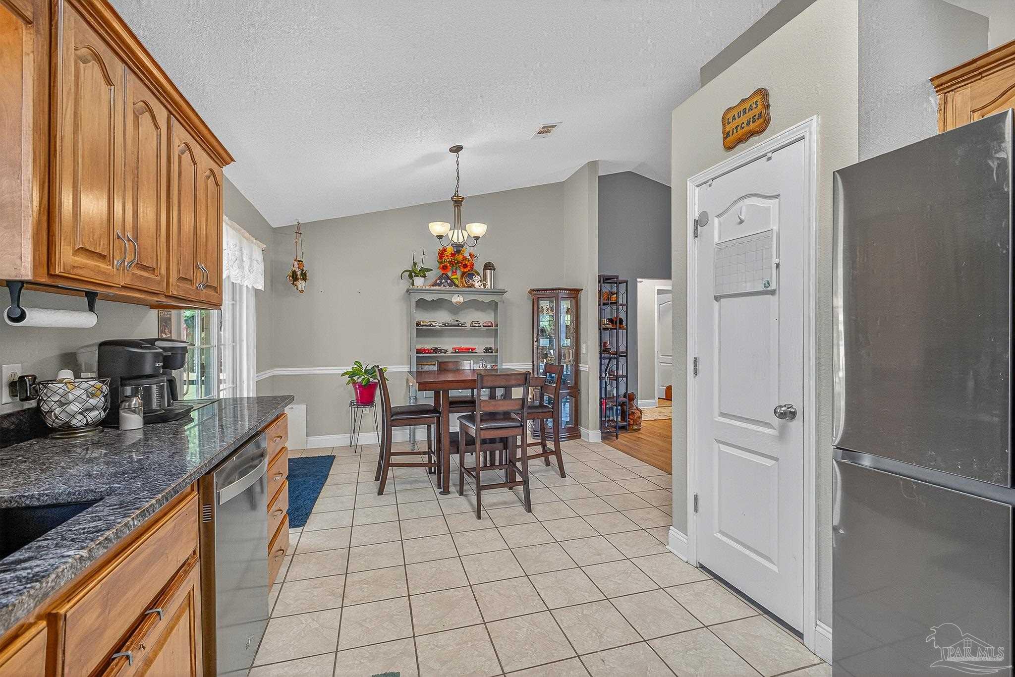 5361 Willard Norris Road Milton, FL 32570 - Photo 16 of 51 a kitchen with stainless steel appliances granite countertop a refrigerator and a sink