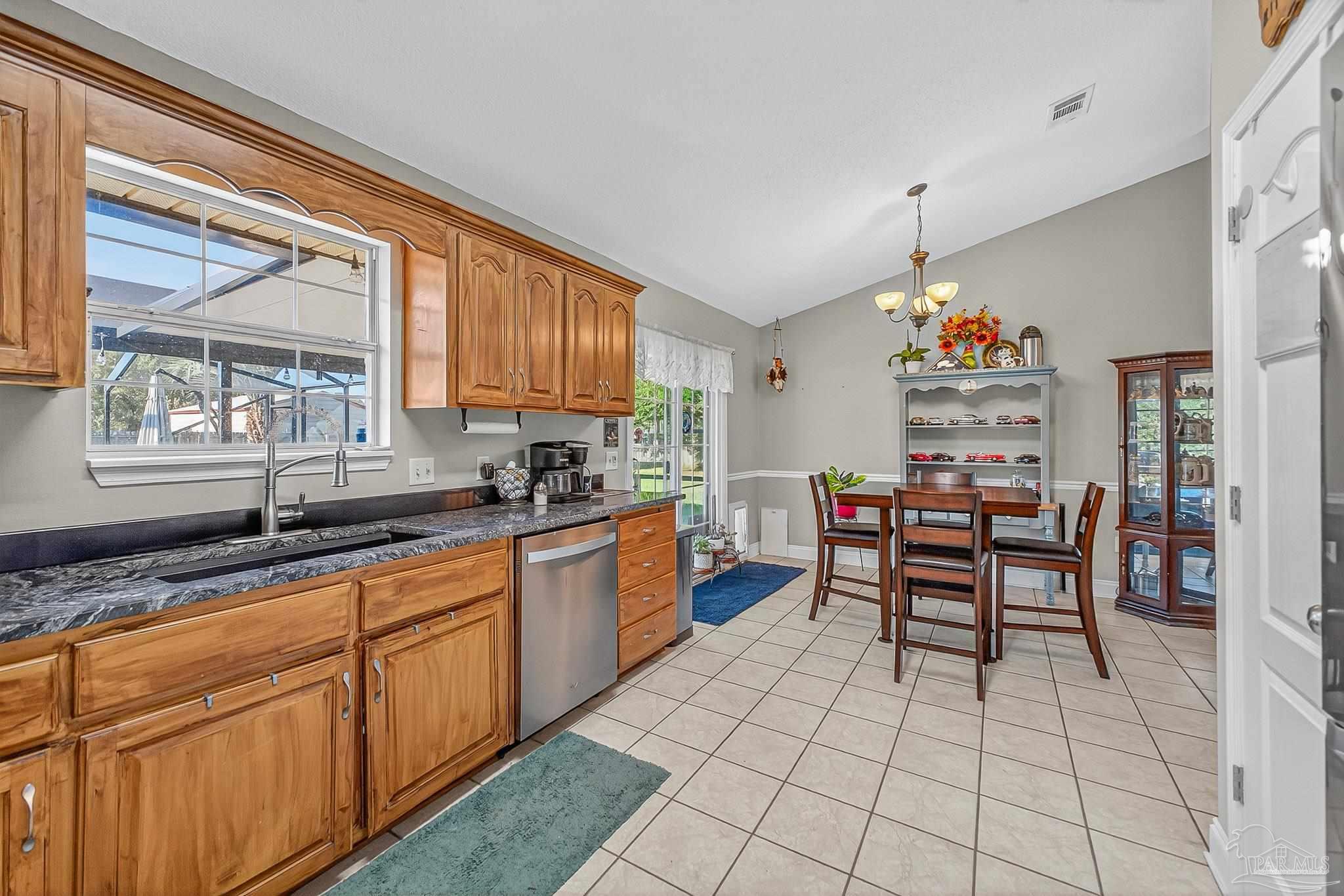 5361 Willard Norris Road Milton, FL 32570 - Photo 17 of 51 a kitchen with granite countertop a sink cabinets and window