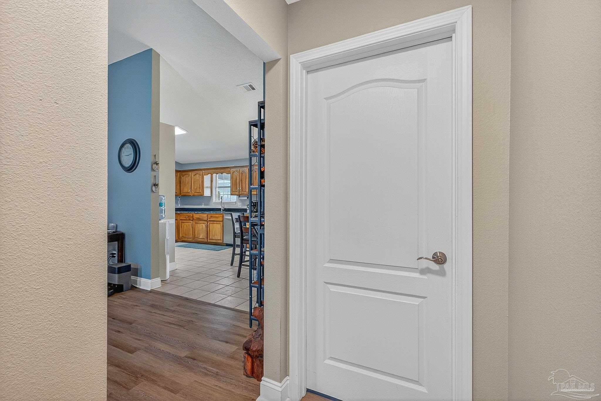 5361 Willard Norris Road Milton, FL 32570 - Photo 21 of 51 a view of a hallway with wooden floor and a living room