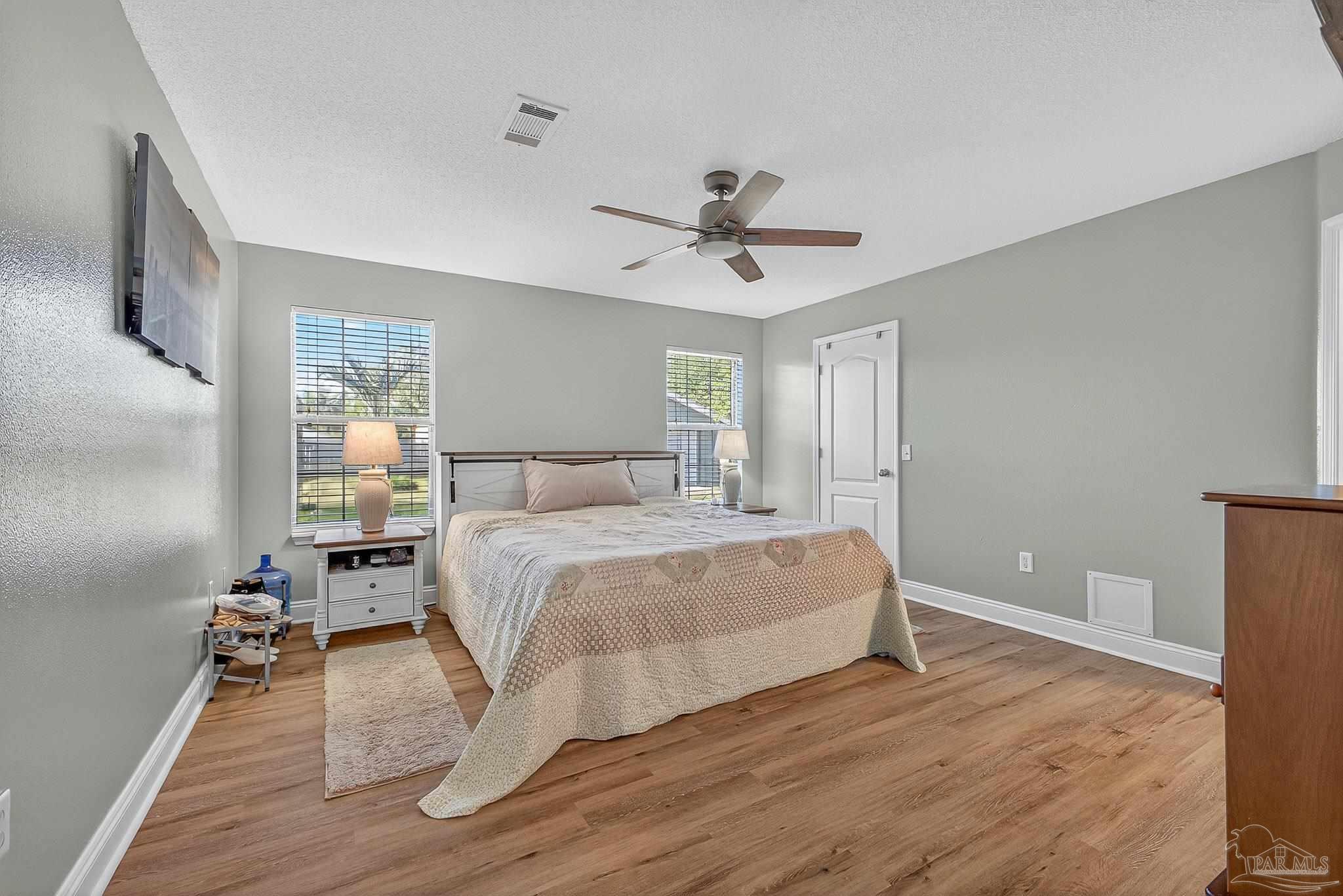 5361 Willard Norris Road Milton, FL 32570 - Photo 22 of 51 a bedroom with a bed and wooden floor