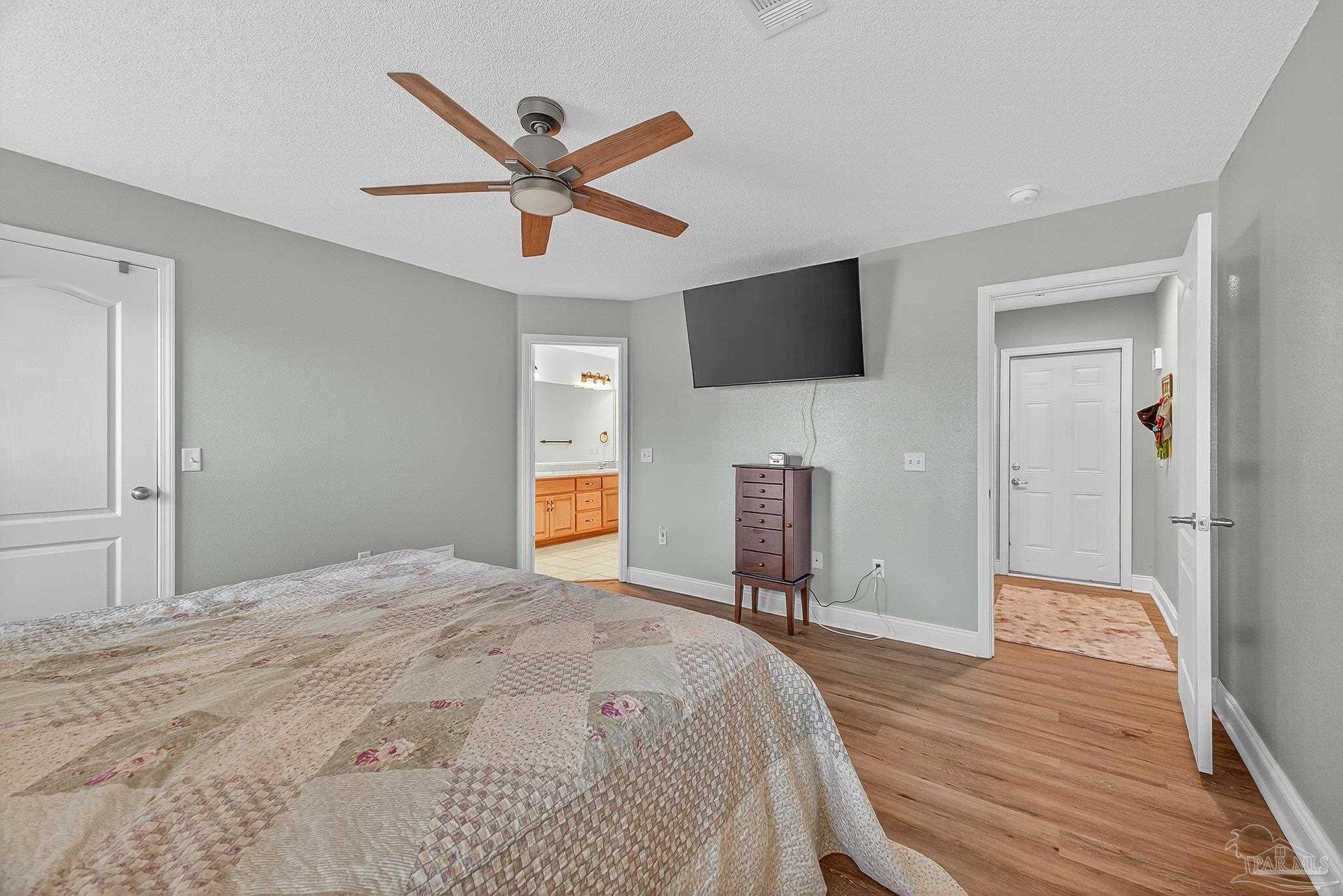 5361 Willard Norris Road Milton, FL 32570 - Photo 24 of 51 a bedroom with a bed and a flat screen tv