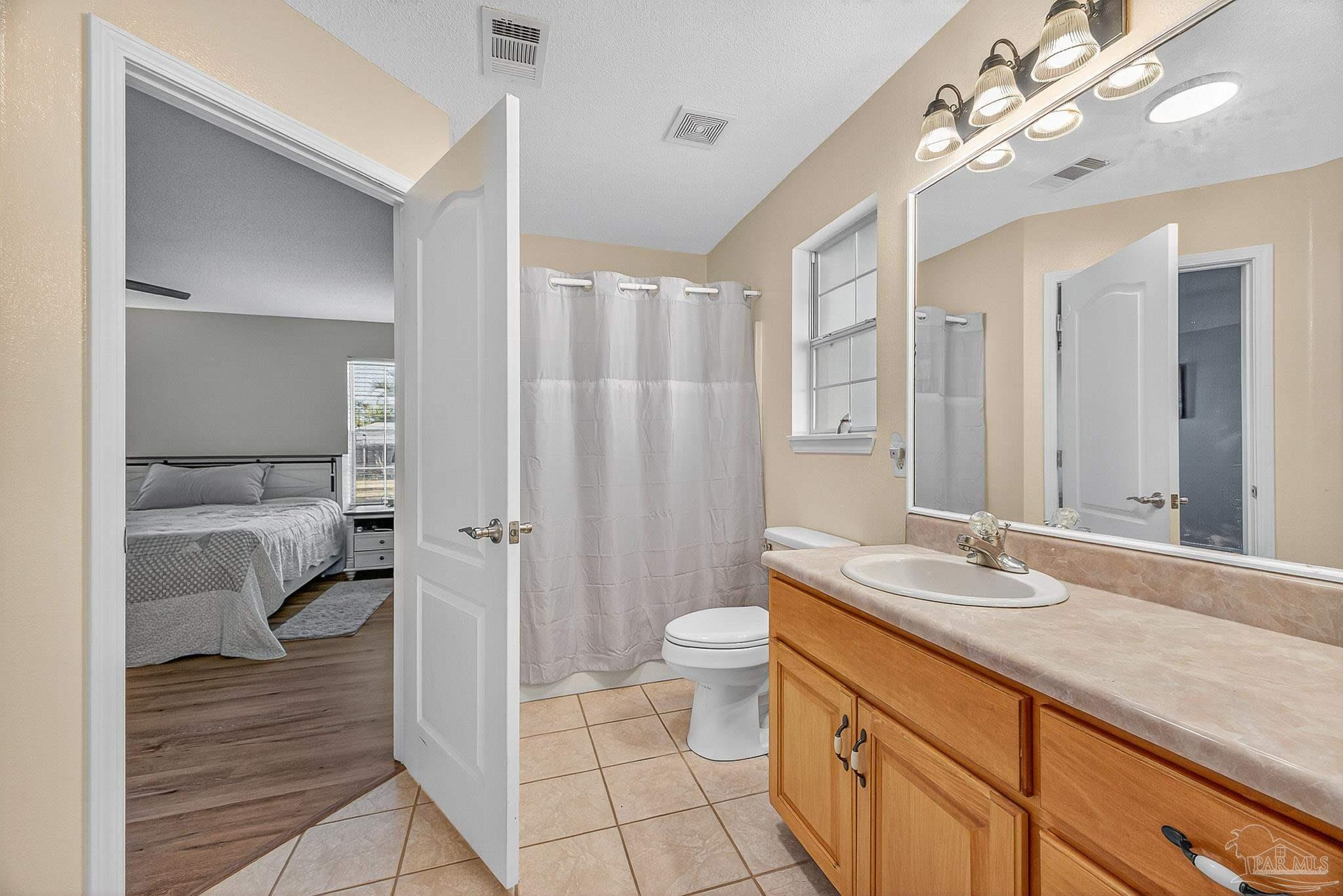 5361 Willard Norris Road Milton, FL 32570 - Photo 27 of 51 a bathroom with a sink a toilet and shower
