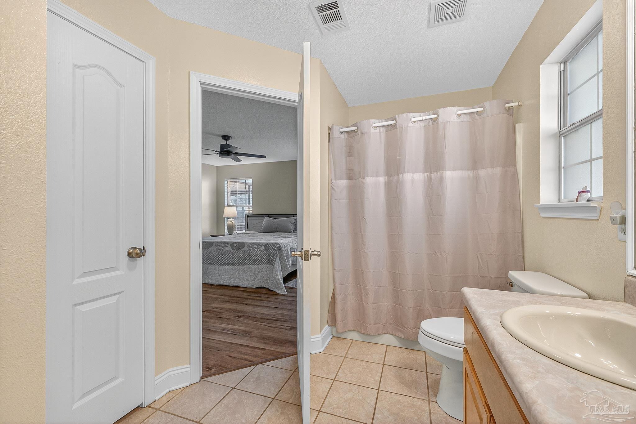 5361 Willard Norris Road Milton, FL 32570 - Photo 28 of 51 a bathroom with a sink a toilet and shower