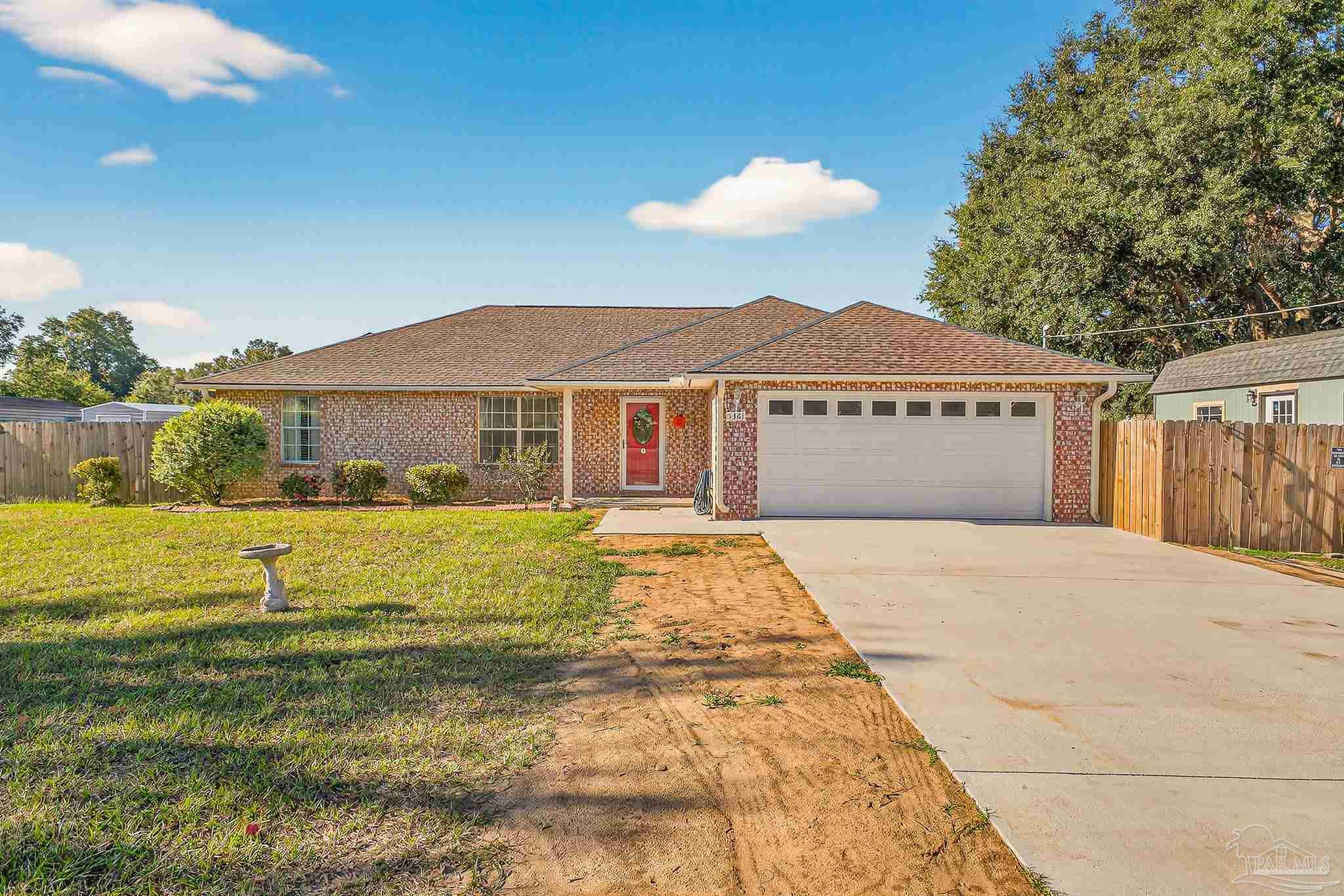 5361 Willard Norris Road Milton, FL 32570 - Photo 3 of 51 a front view of a house with a garden