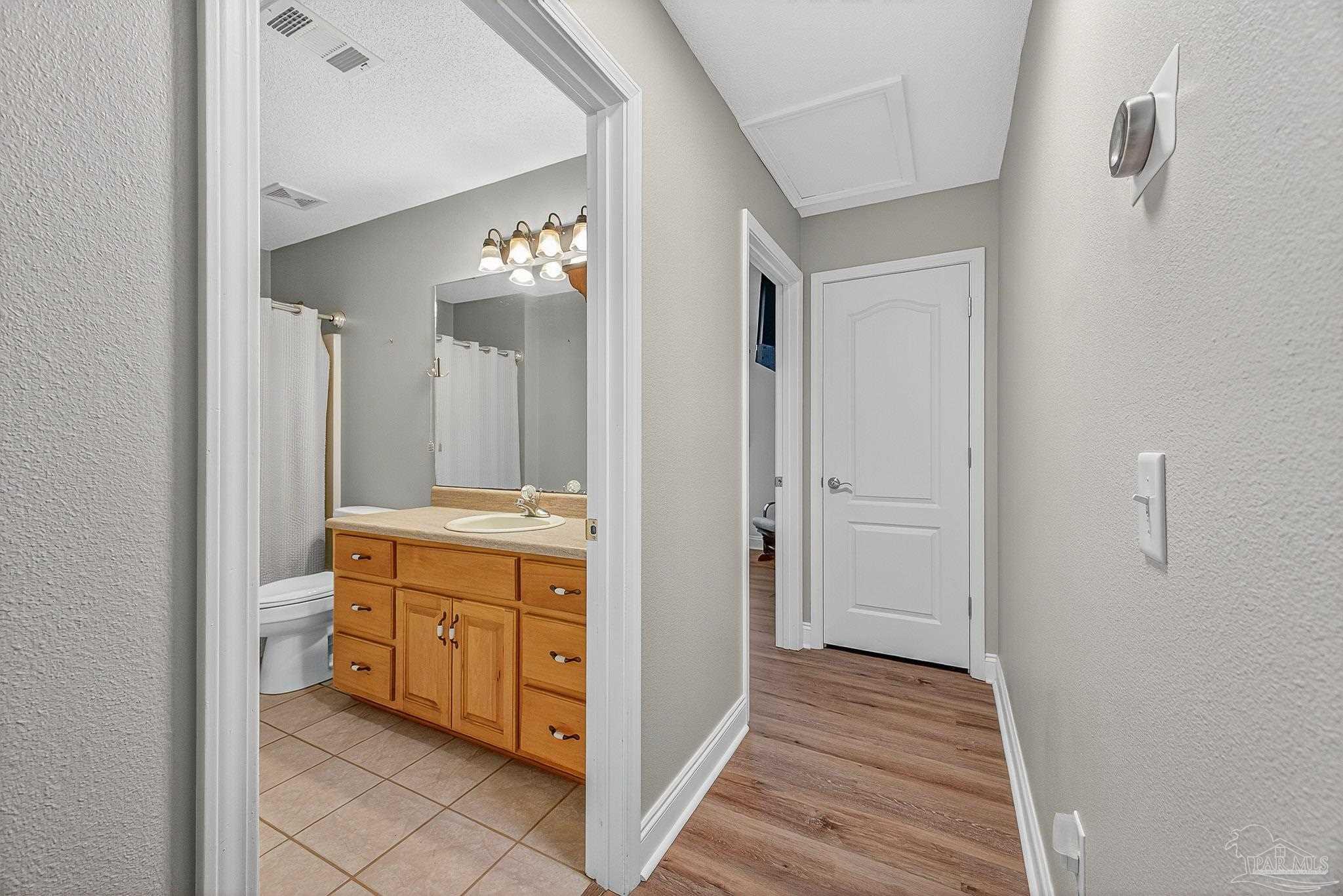 5361 Willard Norris Road Milton, FL 32570 - Photo 32 of 51 a bathroom with a double vanity sink and mirror