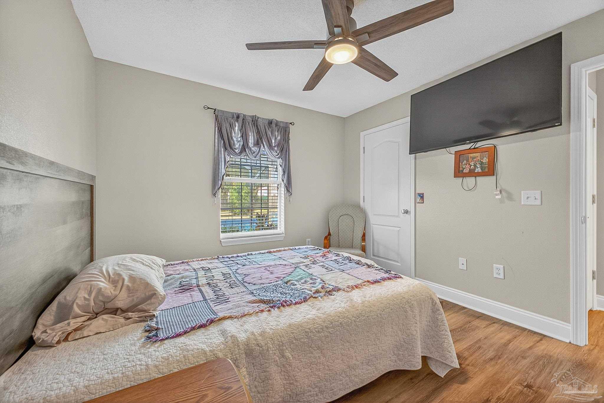 5361 Willard Norris Road Milton, FL 32570 - Photo 36 of 51 a bedroom with a large bed and a window