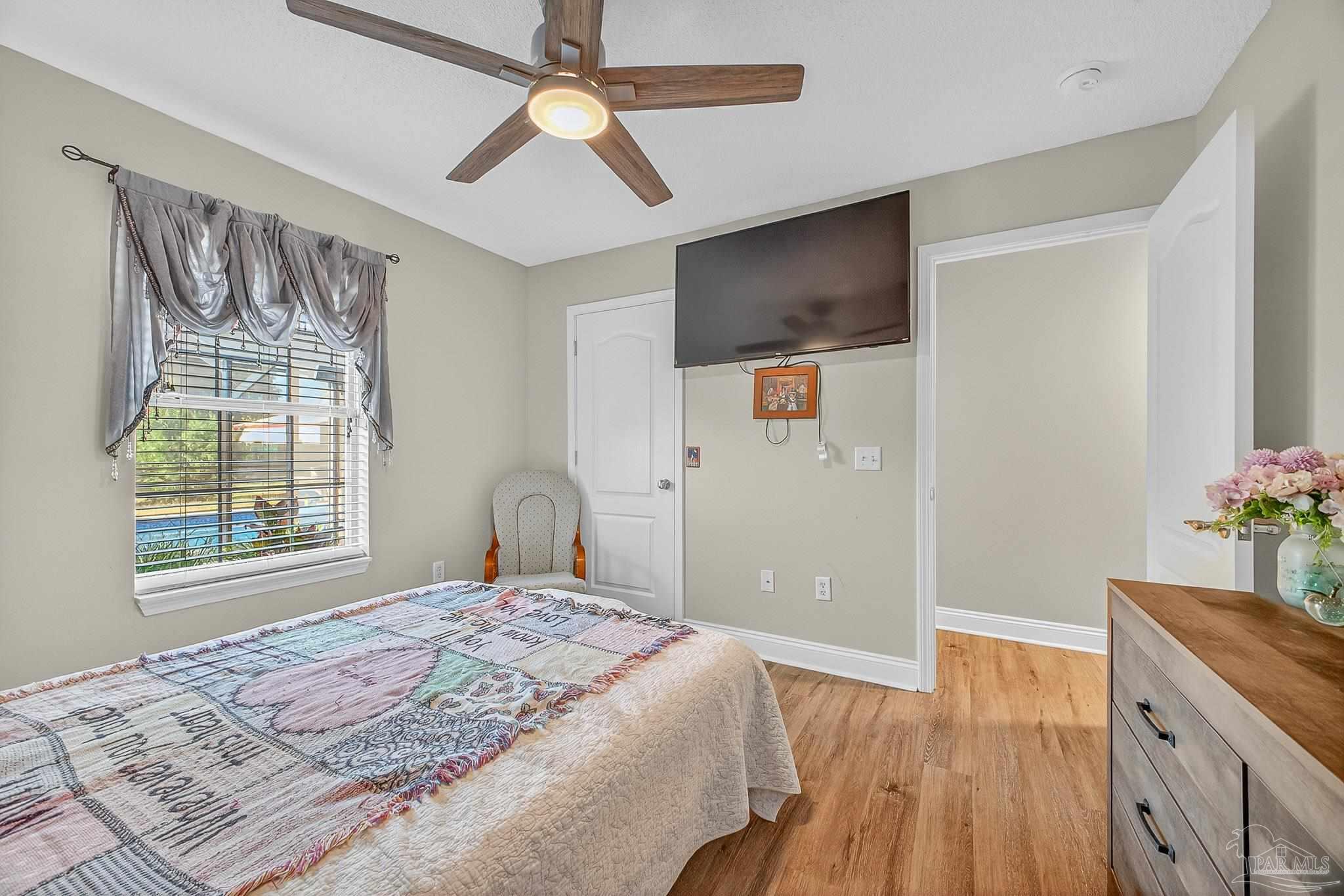 5361 Willard Norris Road Milton, FL 32570 - Photo 37 of 51 a bedroom with a bed and a flat screen tv