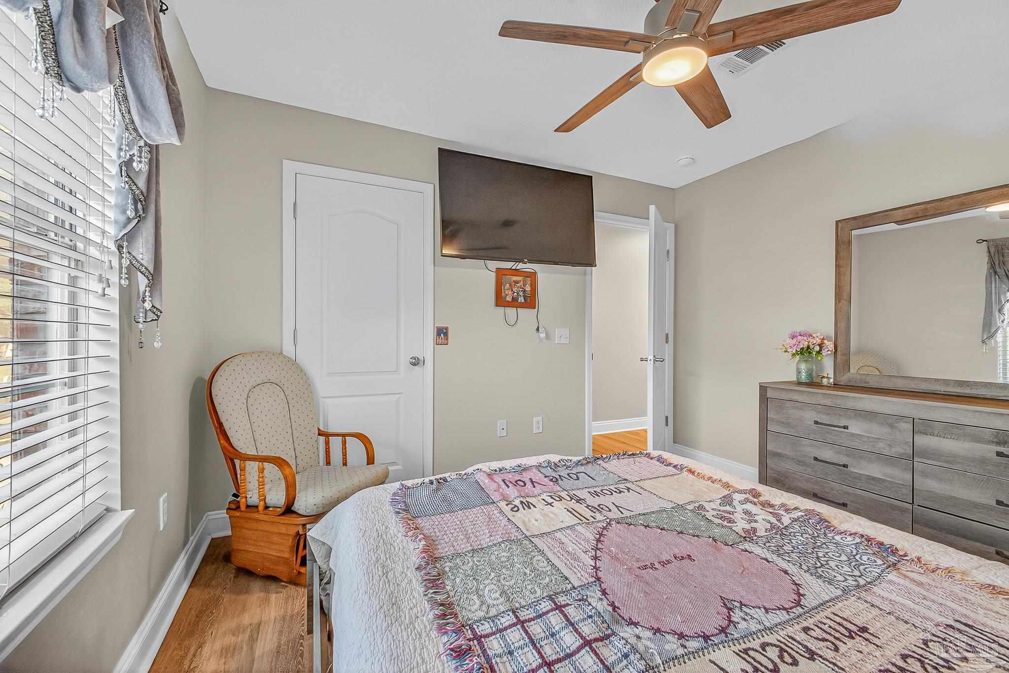 5361 Willard Norris Road Milton, FL 32570 - Photo 38 of 51 a bedroom with a bed and a dresser in it