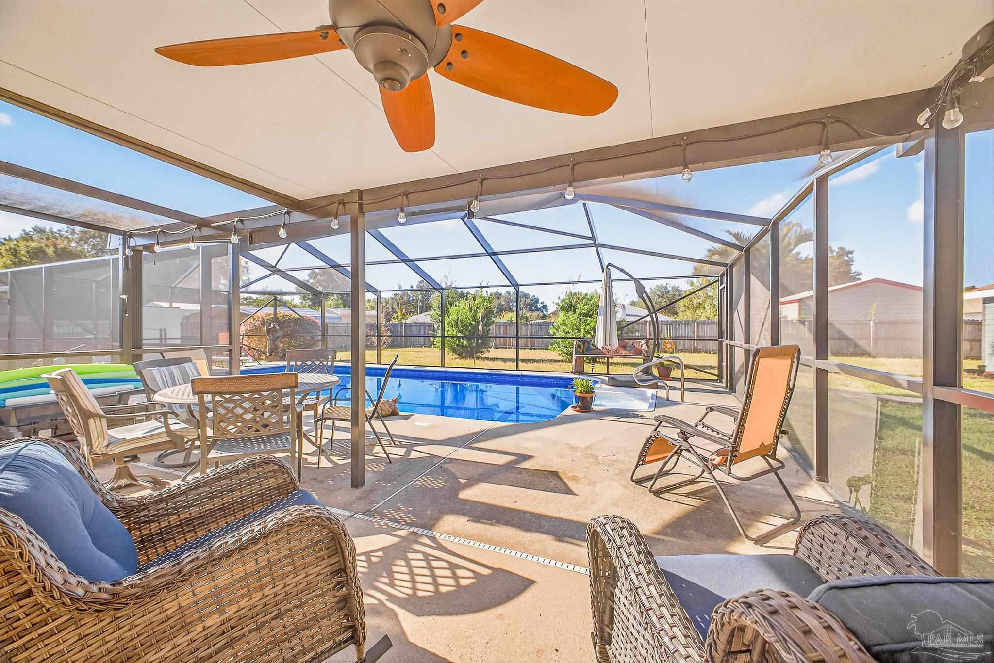 5361 Willard Norris Road Milton, FL 32570 - Photo 39 of 51 a view of a dining room with furniture a chandelier and wooden floor