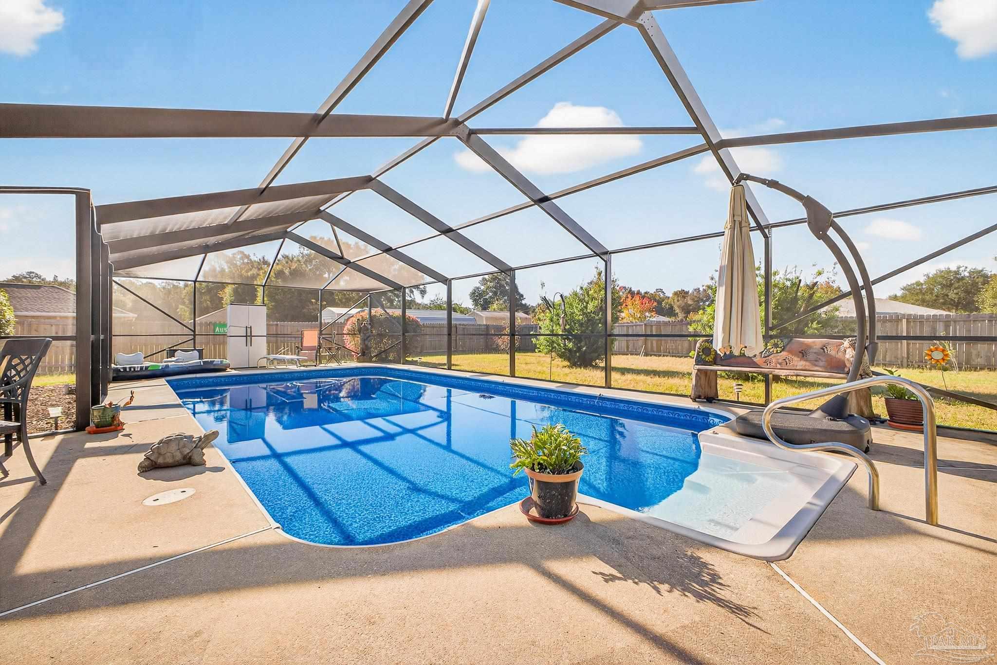 5361 Willard Norris Road Milton, FL 32570 - Photo 40 of 51 a view of a swimming pool with a lounge chairs