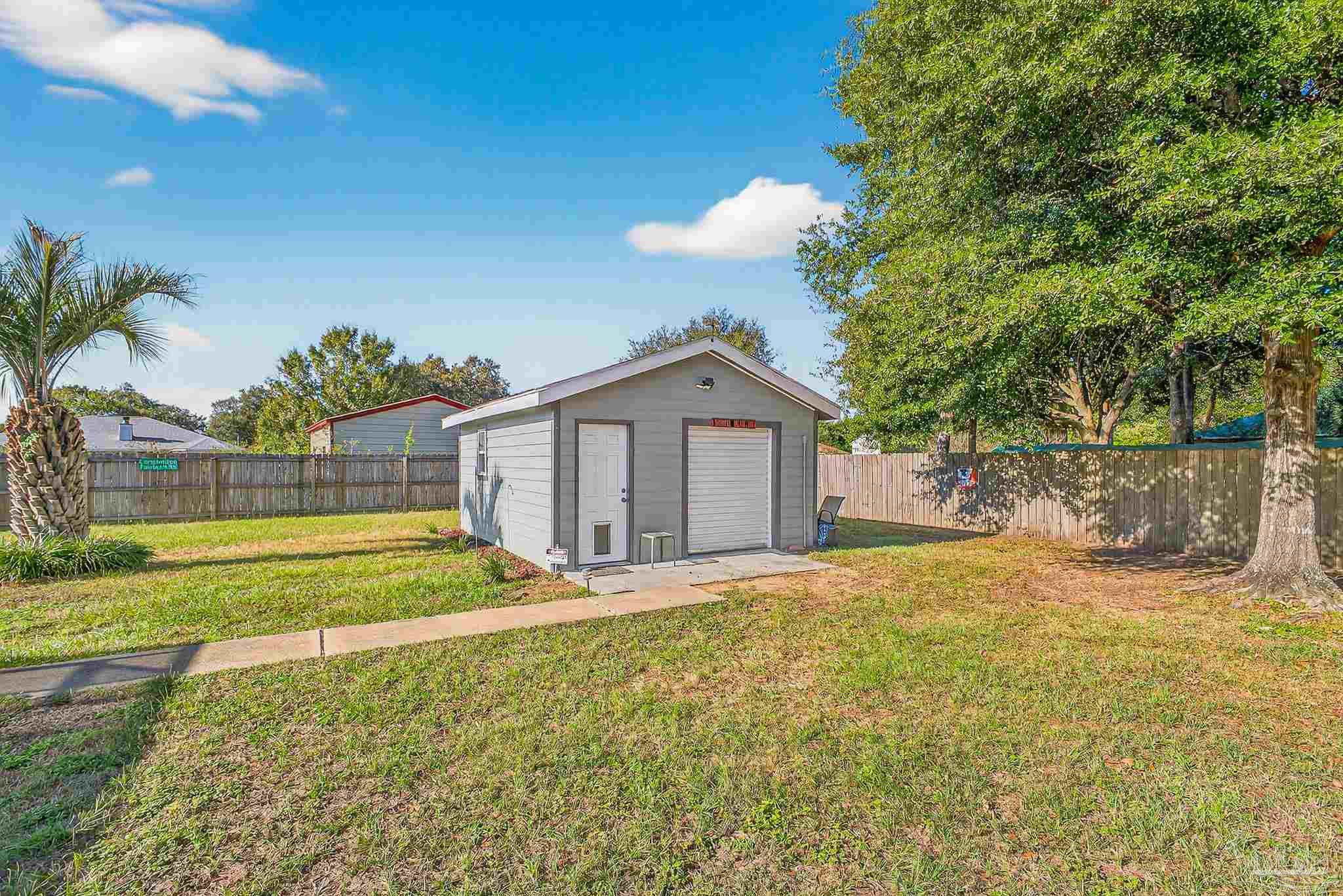 5361 Willard Norris Road Milton, FL 32570 - Photo 43 of 51 a view of a house with a yard and a large tree