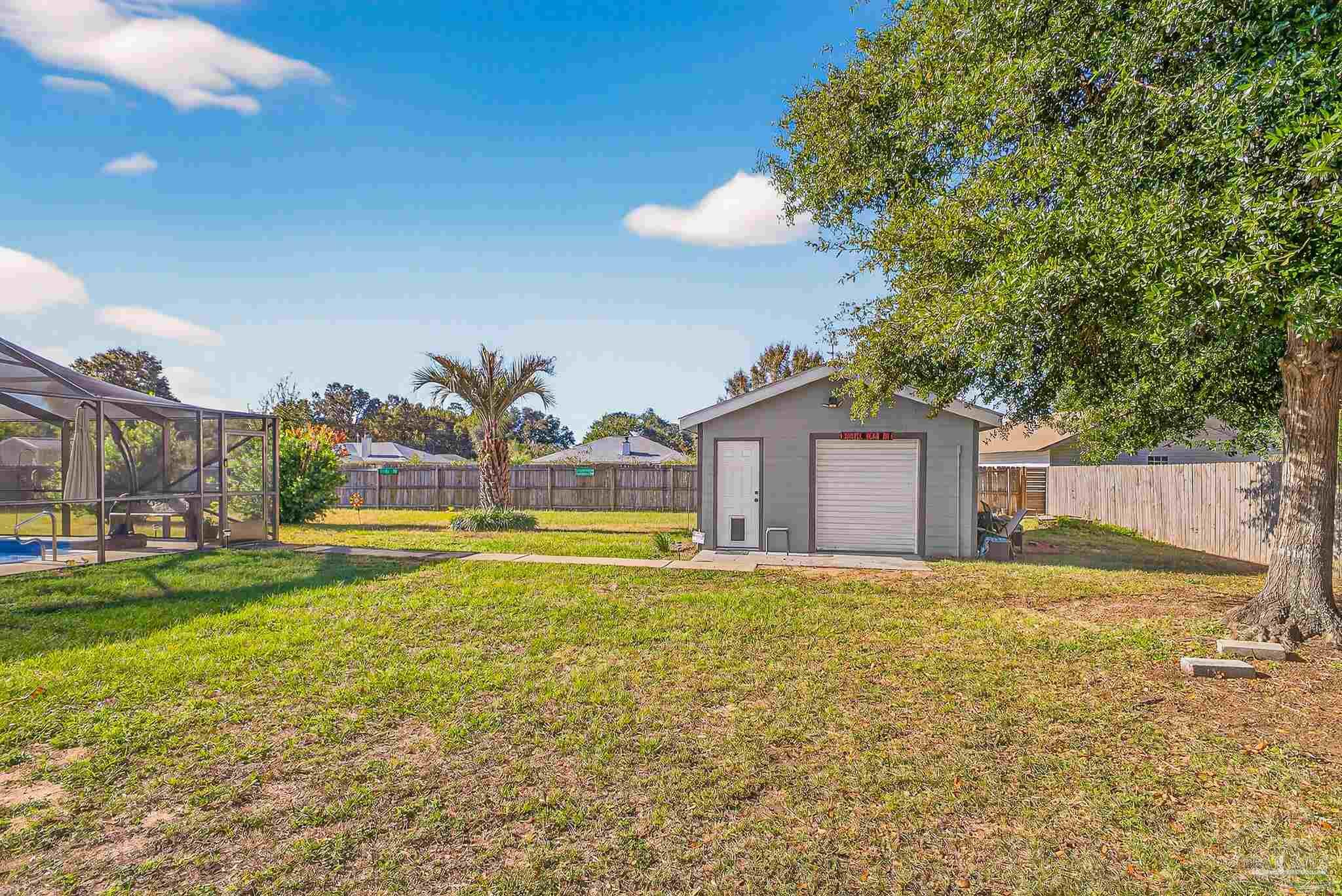 5361 Willard Norris Road Milton, FL 32570 - Photo 45 of 51 a view of a house with a yard and a large tree