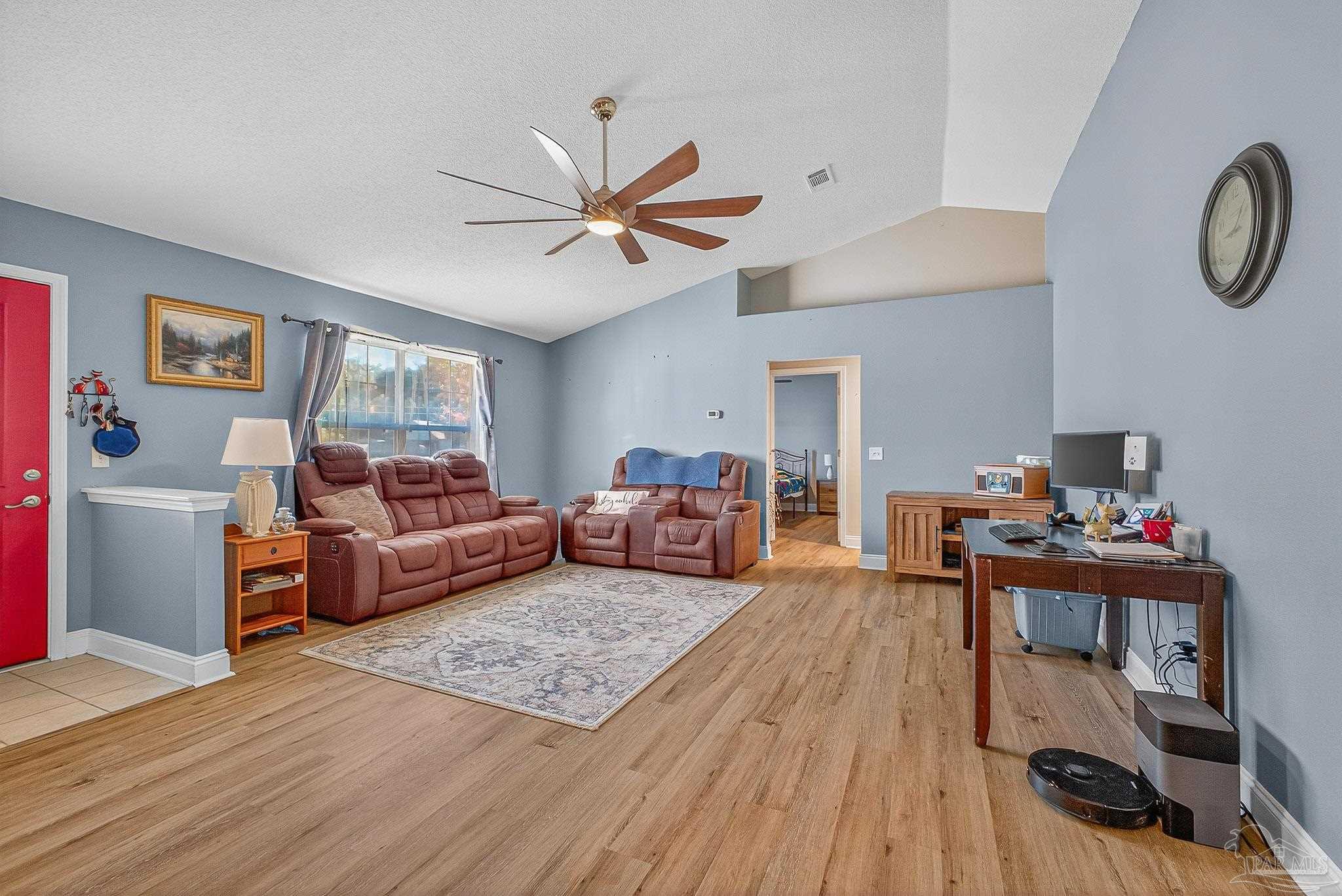 5361 Willard Norris Road Milton, FL 32570 - Photo 6 of 51 a living room with furniture and a wooden floor