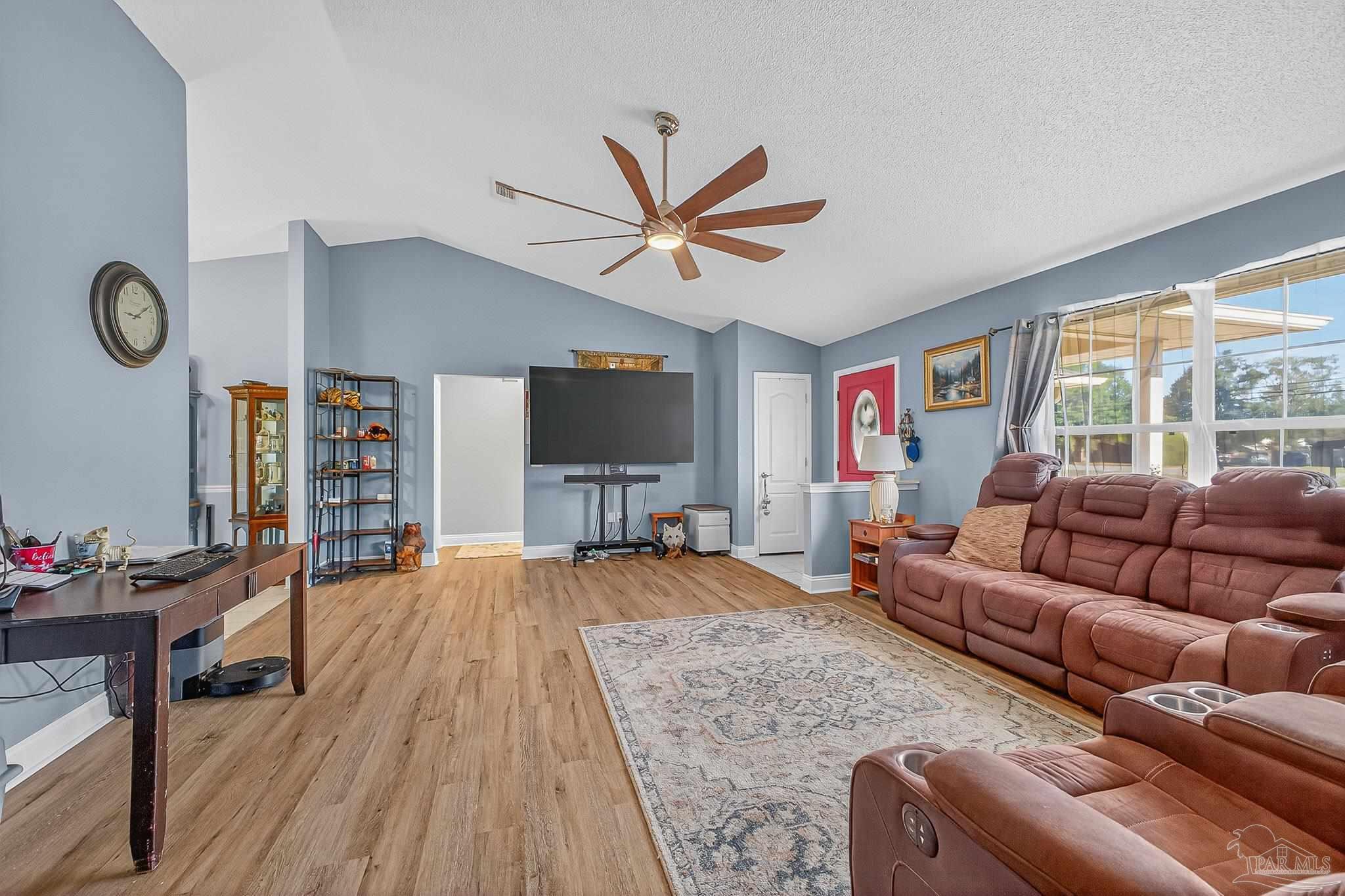 5361 Willard Norris Road Milton, FL 32570 - Photo 8 of 51 a living room with furniture a flat screen tv and a large window