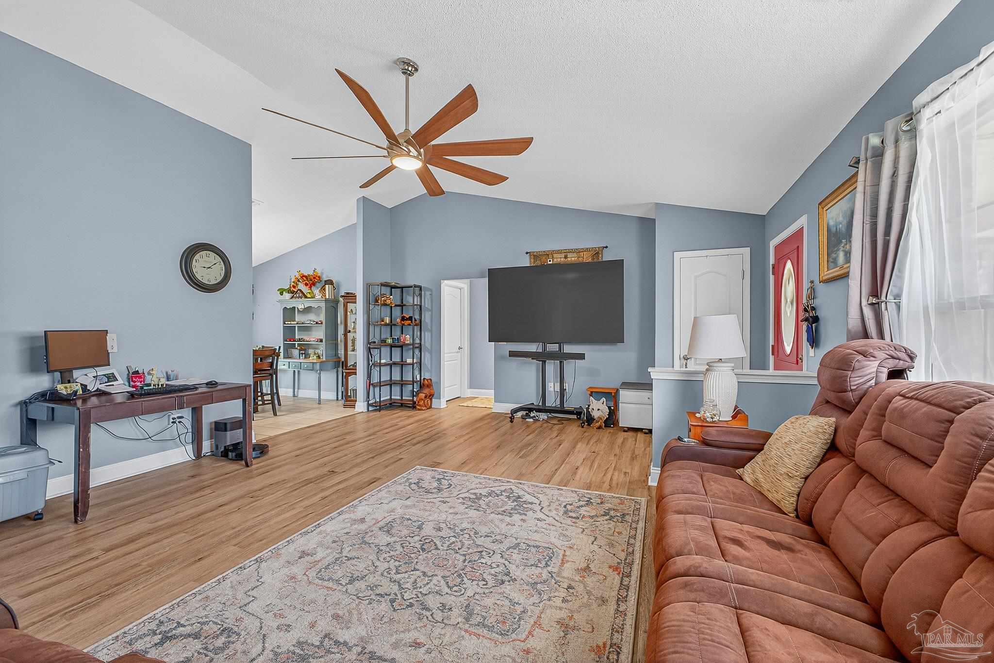 5361 Willard Norris Road Milton, FL 32570 - Photo 9 of 51 a living room with furniture and a flat screen tv