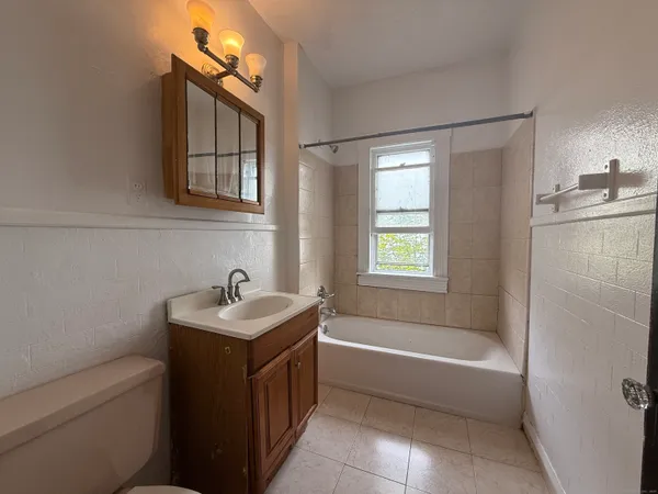 a bathroom with a sink toilet tub and shower