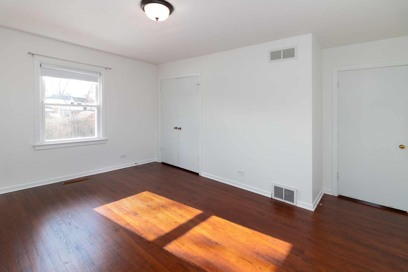 1005 West Pendleton Place Mount Prospect, IL 60056 - Photo 11 of 24 an empty room with wooden floor and windows