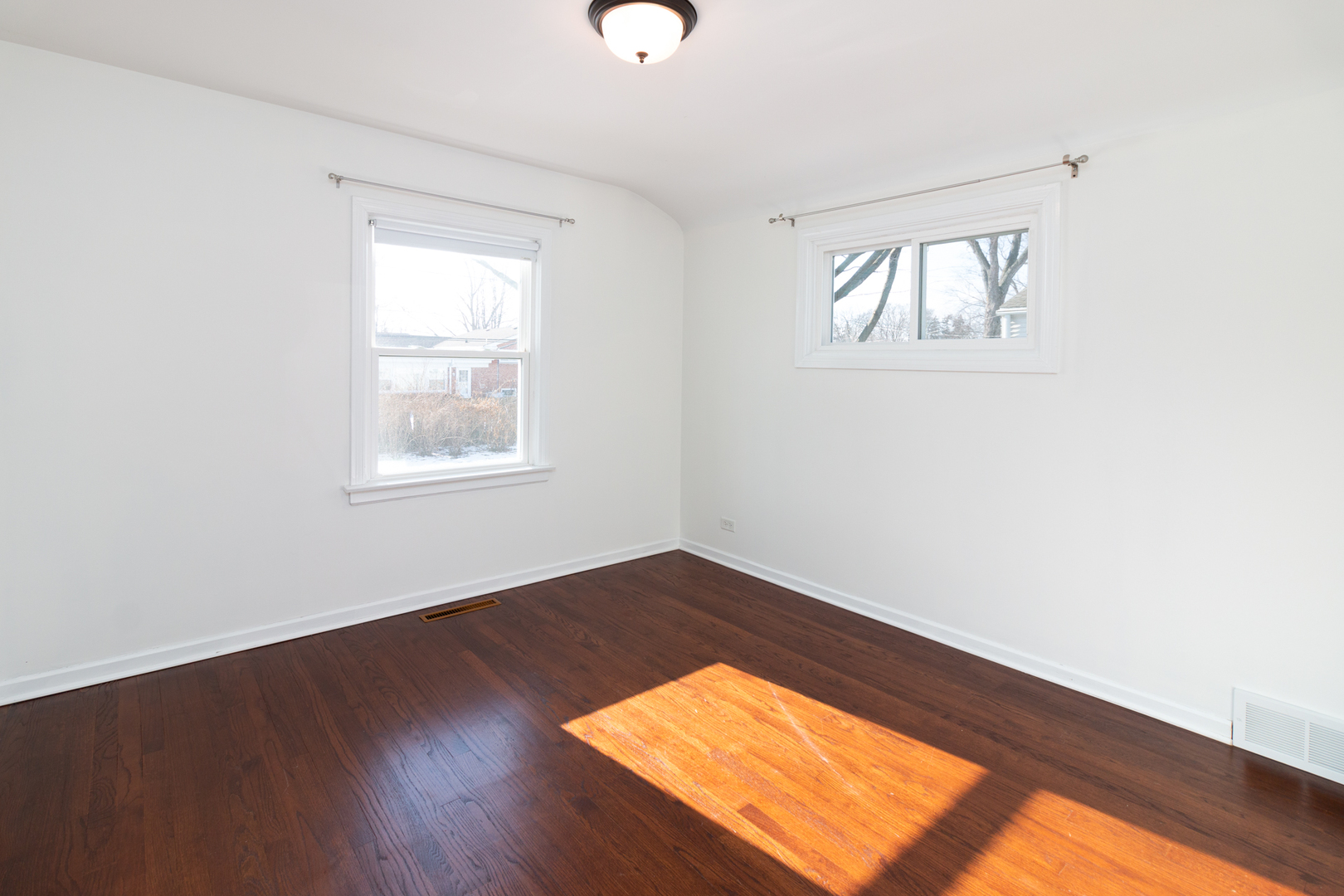 1005 West Pendleton Place Mount Prospect, IL 60056 - Photo 12 of 24 an empty room with wooden floor and windows