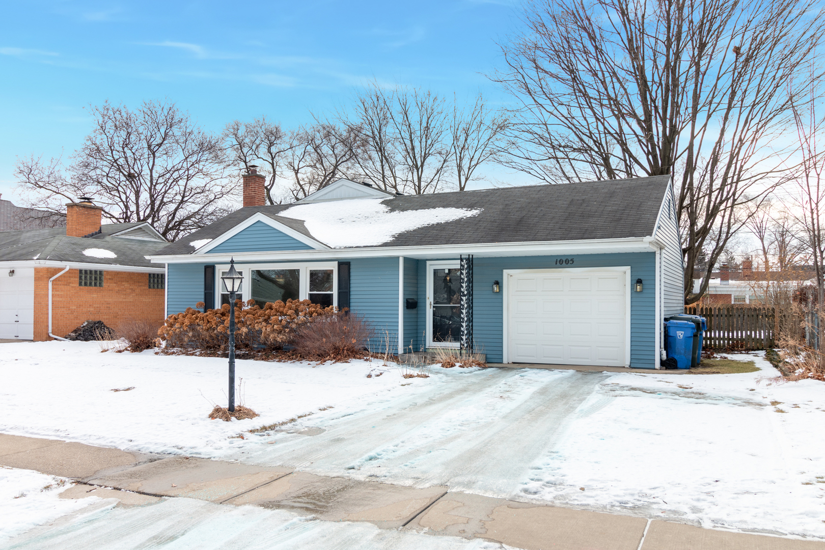 1005 West Pendleton Place Mount Prospect, IL 60056 - Photo 2 of 24 a front view of a house with a yard covered in snow