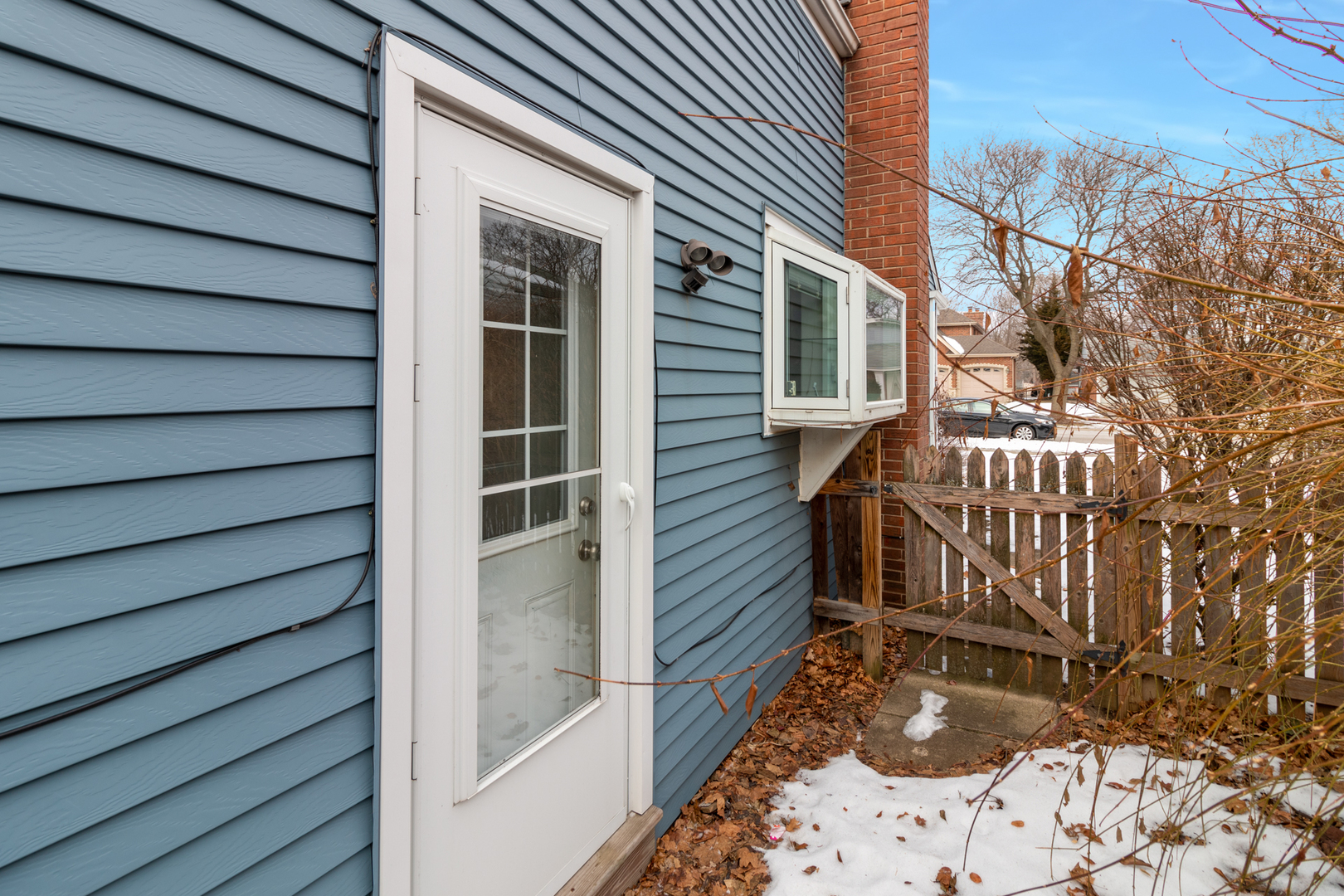 1005 West Pendleton Place Mount Prospect, IL 60056 - Photo 23 of 24 a view of a house with a door and wooden bench