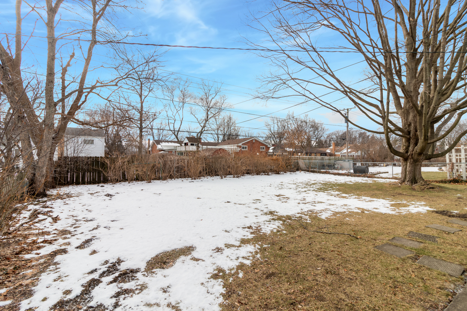 1005 West Pendleton Place Mount Prospect, IL 60056 - Photo 24 of 24 a view of a yard covered in snow
