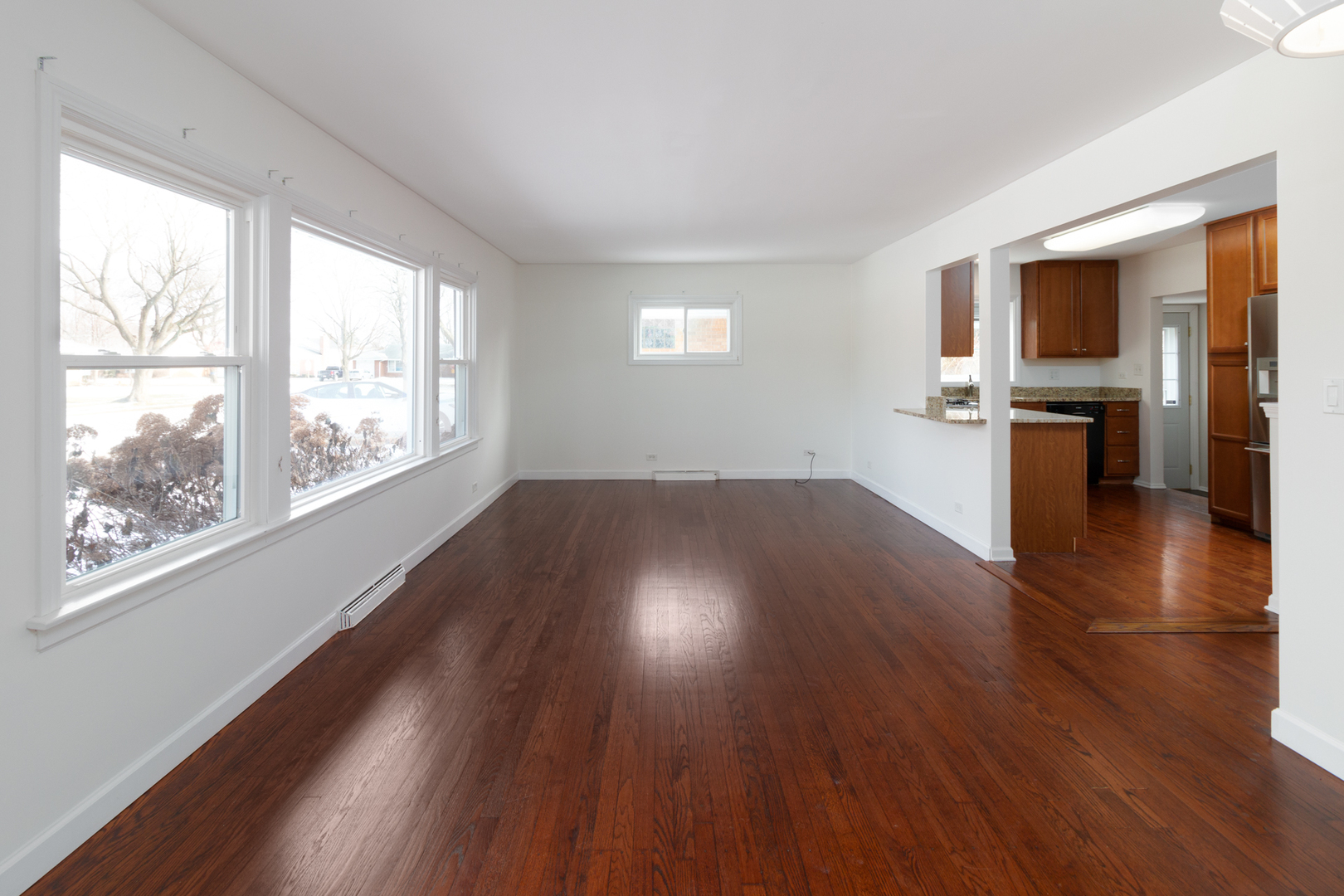 1005 West Pendleton Place Mount Prospect, IL 60056 - Photo 3 of 24 a view of empty room with wooden floor and fan