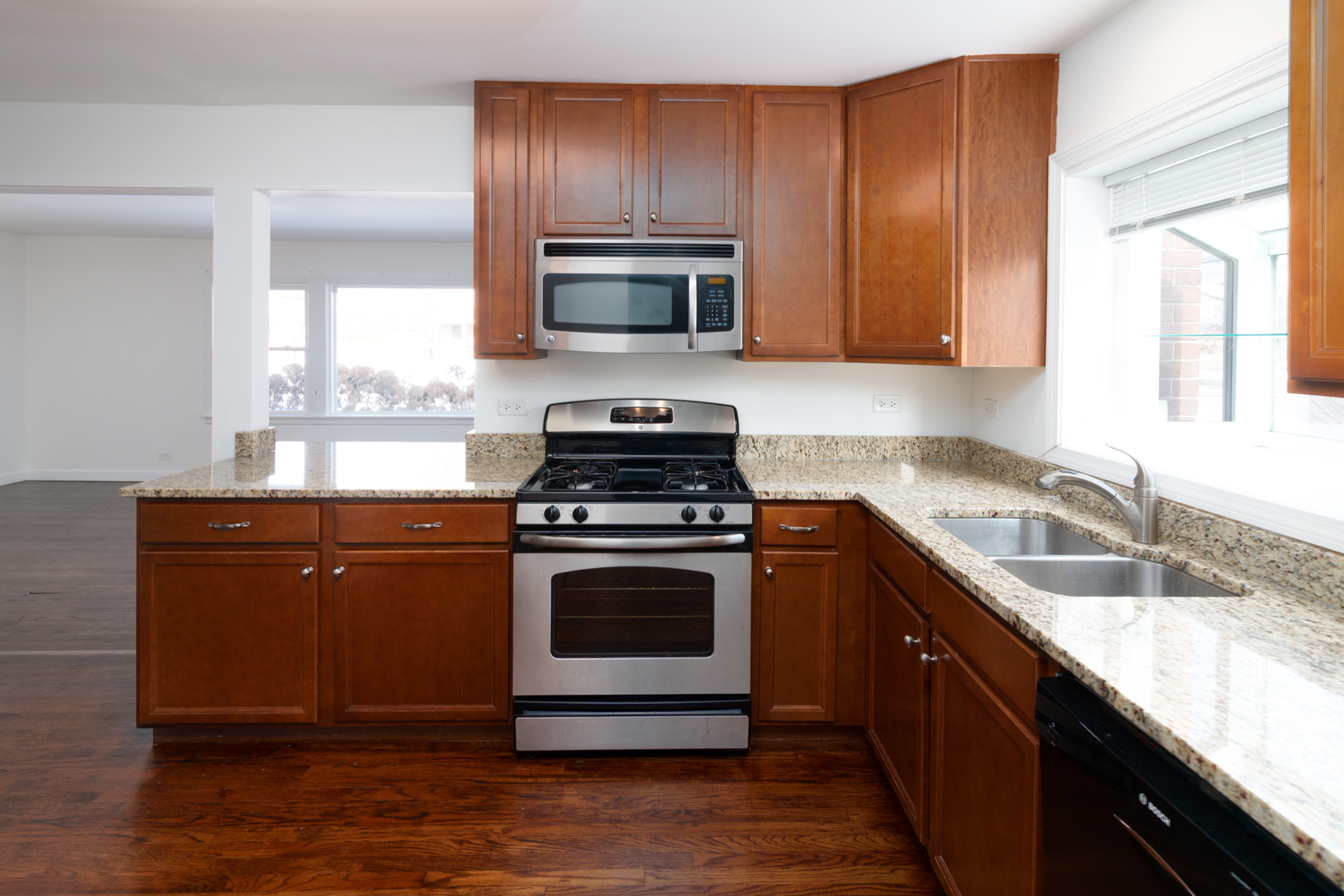 1005 West Pendleton Place Mount Prospect, IL 60056 - Photo 6 of 24 a kitchen with stainless steel appliances granite countertop a sink stove and microwave