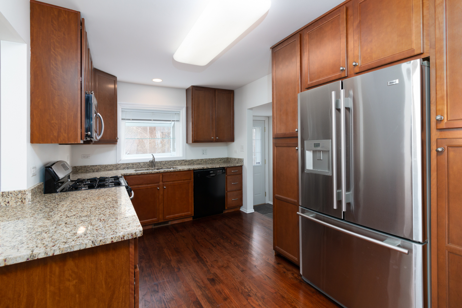 1005 West Pendleton Place Mount Prospect, IL 60056 - Photo 7 of 24 a kitchen with stainless steel appliances granite countertop a refrigerator a sink and a stove