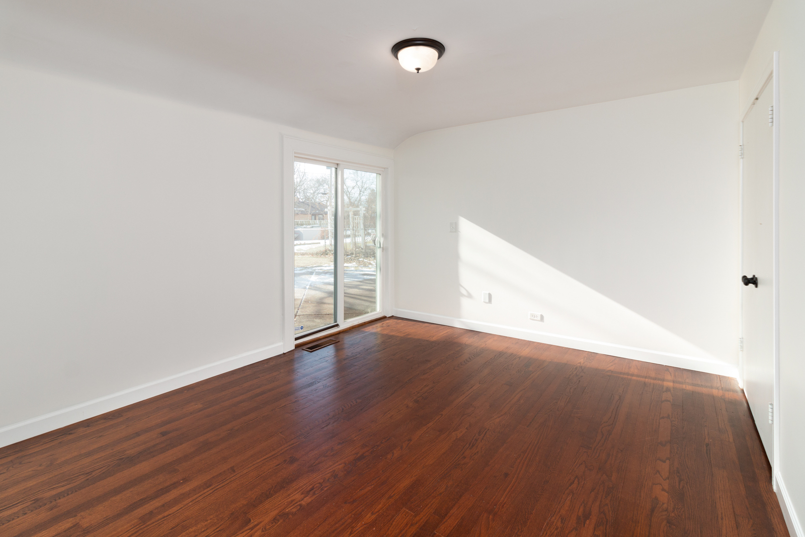 1005 West Pendleton Place Mount Prospect, IL 60056 - Photo 9 of 24 an empty room with wooden floor and windows