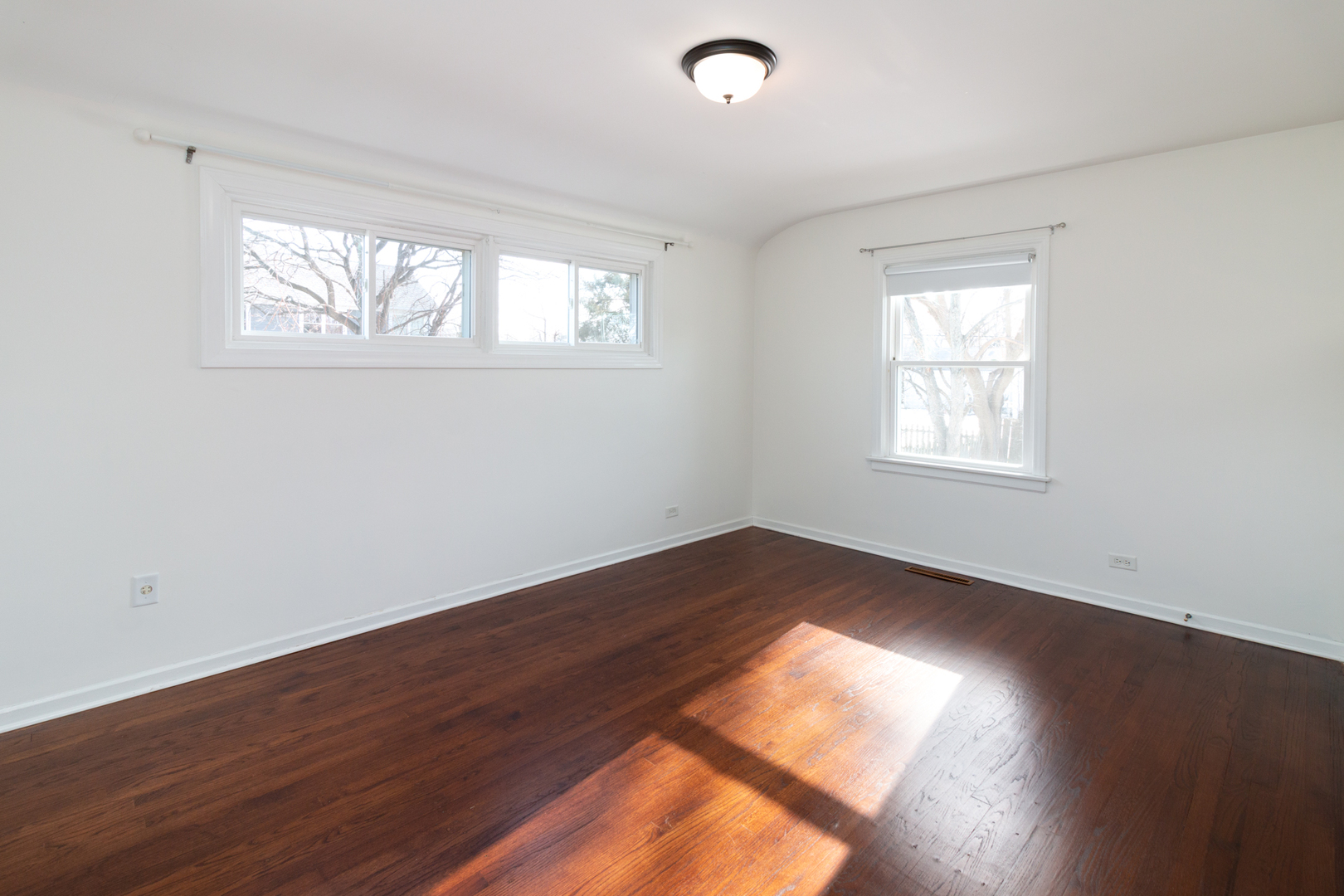 1005 West Pendleton Place Mount Prospect, IL 60056 - Photo 10 of 24 a view of an empty room with wooden floor and a window