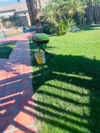 a view of a backyard with swimming pool