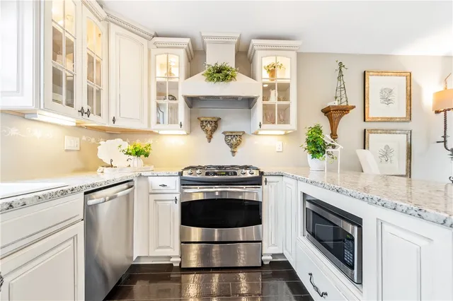 a kitchen with granite countertop a refrigerator and a sink