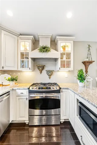 a view of a hallway with wooden floor and windows