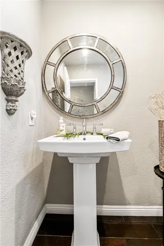 a bathroom with a sink vanity and mirror