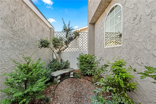 a front view of a house with lots of flowers