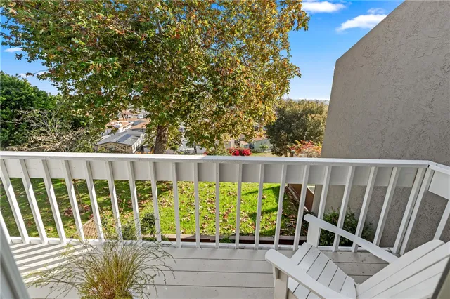 a view of a patio with table and chairs potted plants with wooden floor and fence