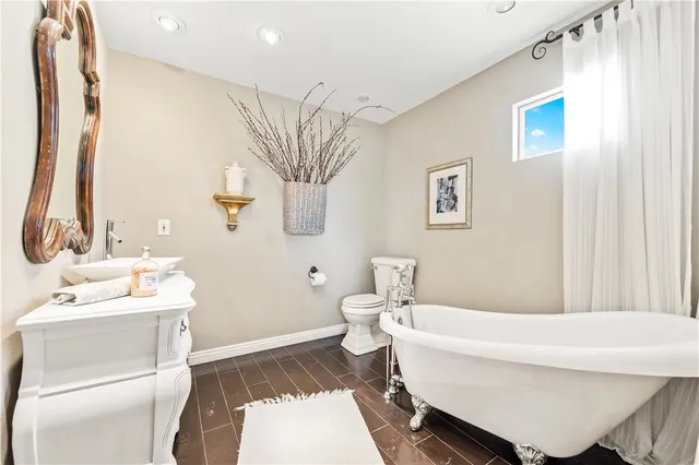 a view of a tennis ground with large trees