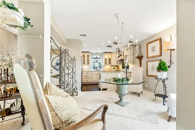 a dining room with furniture a chandelier and wooden floor