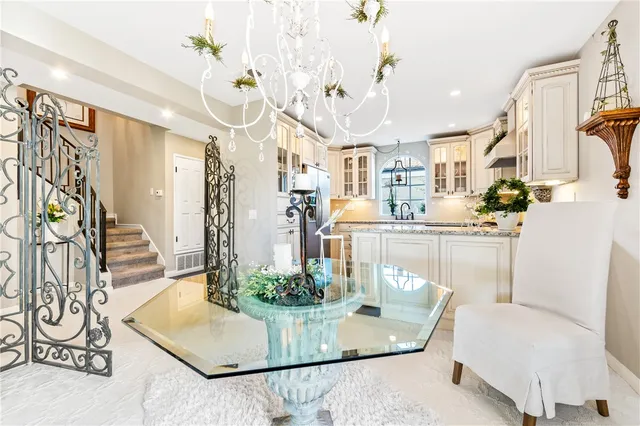 a kitchen with stainless steel appliances granite countertop a stove and white cabinets