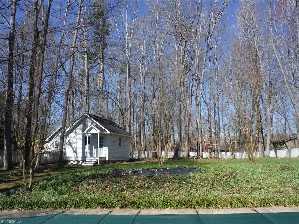 1801 Neelley Road Pleasant Garden, NC 27313 - Photo 2 of 20 Great fenced backyard with 22 x 38 in-ground pool, large deck, 16 x 16 storage building w/ utility door in rear.