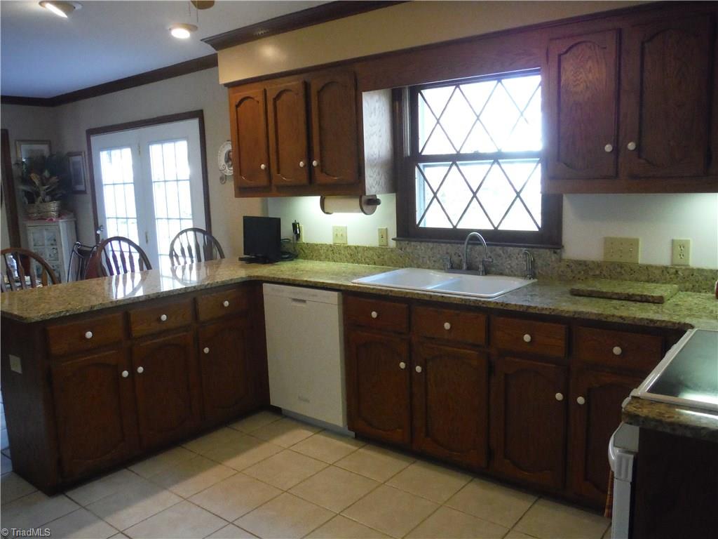 1801 Neelley Road Pleasant Garden, NC 27313 - Photo 6 of 20 Great U-shaped work space in kitchen with granite countertops...Convenient bar seating - note easy-access to outdoors/ deck from breakfast area!