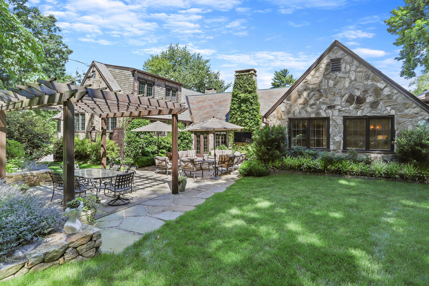 a view of a house with a yard and sitting area