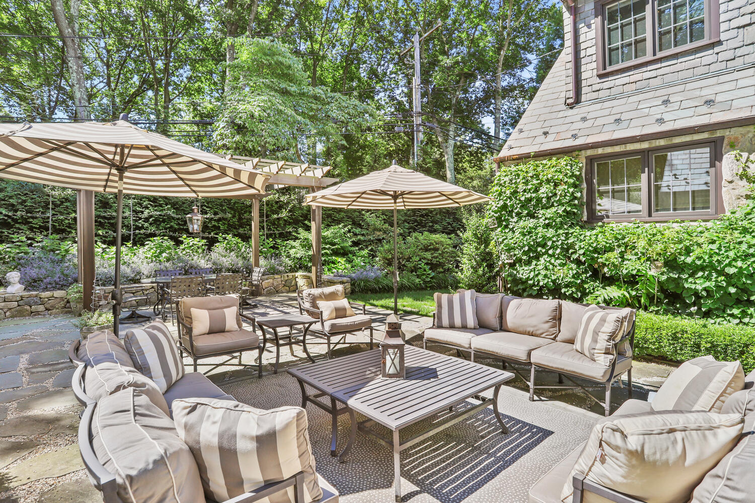 13 Searles Road Darien, CT 06820 - Photo 31 of 35 a view of a patio with couches table and chairs under an umbrella with a barbeque