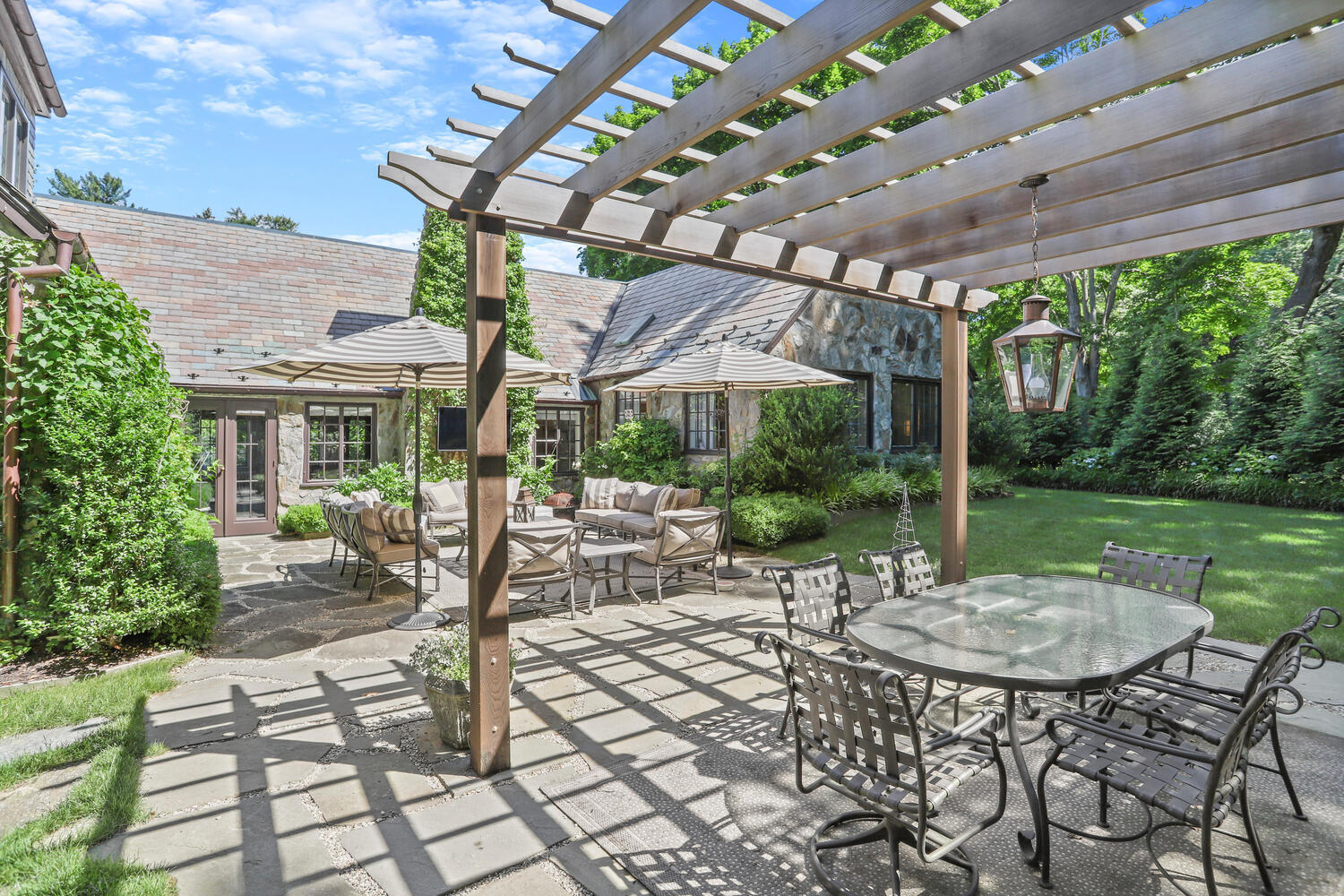 13 Searles Road Darien, CT 06820 - Photo 32 of 35 a view of a patio with a table chairs and a backyard