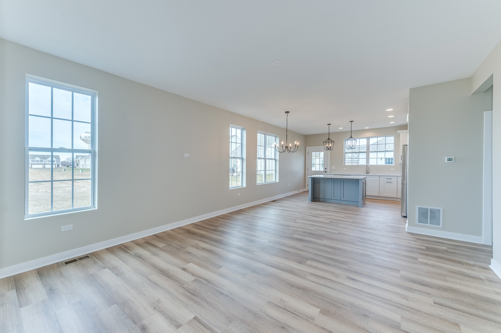 1104 Freedom Road Elburn, IL 60119 - Photo 4 of 24 a view of an empty room with wooden floor and a window