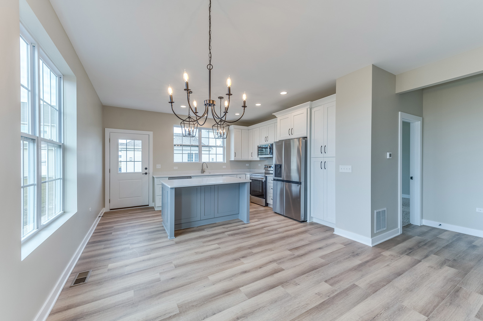 1104 Freedom Road Elburn, IL 60119 - Photo 5 of 24 a open kitchen with stainless steel appliances granite countertop a refrigerator and a wooden floor